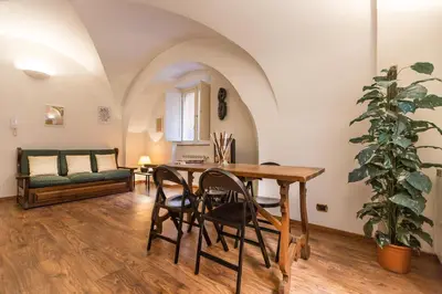 a living room with a table and chairs and a couch at Lovely New Home, Via Nazionale in Rome