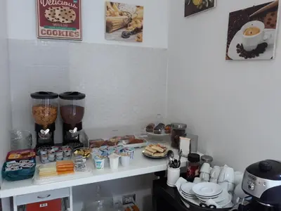 a kitchen counter with some food on a shelf at B&B A Home in Rome in Rome