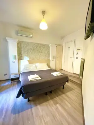 a bedroom with a bed with two towels on it at B&B A Home in Rome in Rome