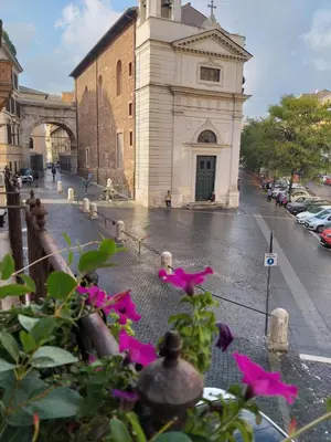 a building with pink flowers in front of it at B&B A Home in Rome in Rome