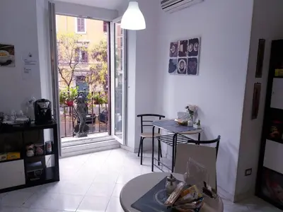 a room with a table and a window and a table and chairs at B&B A Home in Rome in Rome