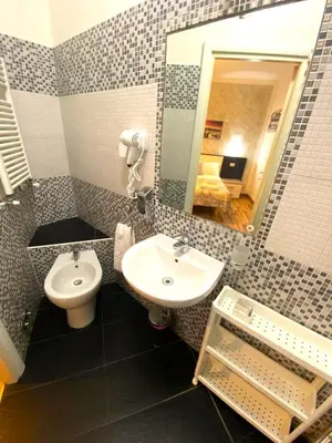 a bathroom with a sink and a toilet at B&B A Home in Rome in Rome