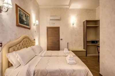 a bedroom with a bed with two phones on it at AMICI GUESTHOUSE in Rome
