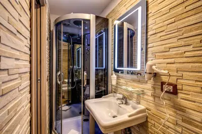 a bathroom with a sink and a glass shower at AMICI GUESTHOUSE in Rome