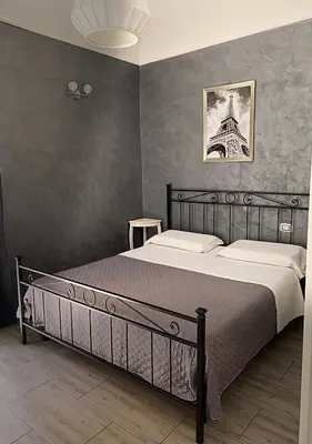 a bedroom with a bed and a picture of the eiffel tower at Babyface in Rome