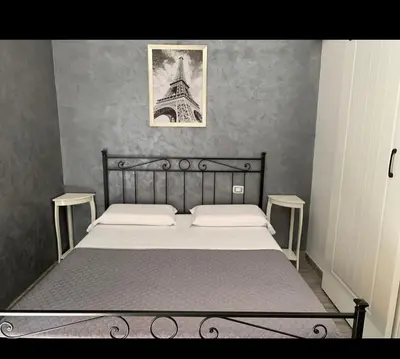 a bedroom with a bed and a picture of the eiffel tower at Babyface in Rome