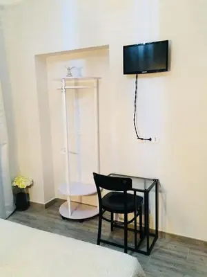 a room with a black chair and a glass table at Babyface in Rome