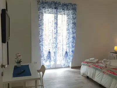 a room with a window with a bed and a table at 550 Special home in Rome