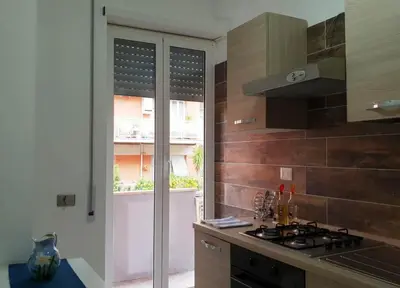a kitchen with a stove top oven next to a window at 550 Special home in Rome