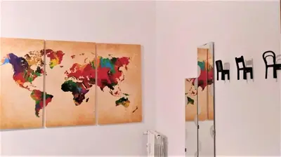 four paintings of a world map on a wall at 550 Special home in Rome