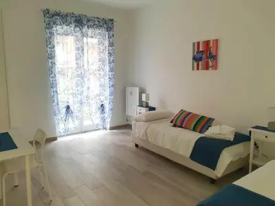 a bedroom with a bed and a large window at 550 Special home in Rome