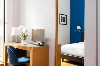 a bedroom with a desk with a computer monitor and a bed at Sky Blue Place Rome in Rome