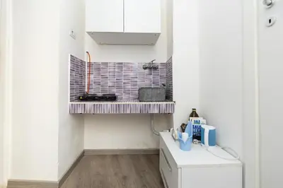 a small kitchen with a shelf on the wall at Imperiale Top in Rome