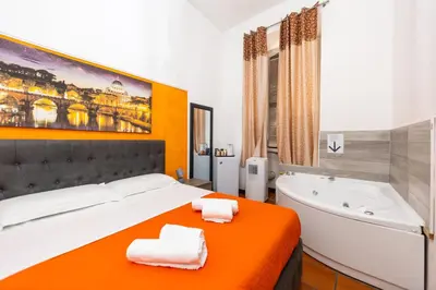 a bedroom with a large bed and a bath tub at Imperiale Top in Rome