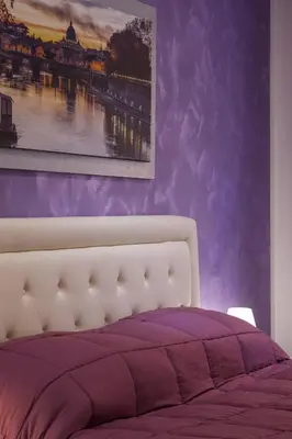 a bedroom with purple walls with a bed and a painting at Imperiale Top in Rome