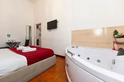 a bathroom with a tub and a bed and a bath tub at Imperiale Top in Rome