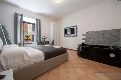 a bedroom with a large bed and a piano at Imperiale Top in Rome