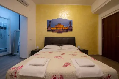 a bedroom with a large bed with two chairs at Imperiale Top in Rome