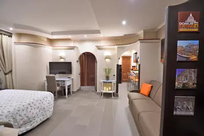 a hotel room with a bed and a couch and a desk at Domus Catone in Rome