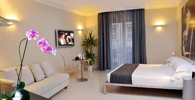 a bedroom with a white bed and a white couch at B&B Best Pantheon in Rome