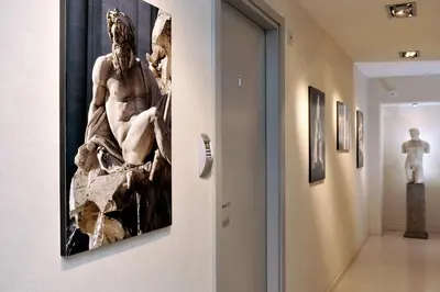 a museum hallway with a statue on the wall at B&B Best Pantheon in Rome
