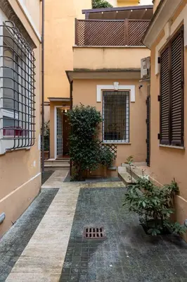 a courtyard of a building with a gate and a drain at Colosseum private terrace in Rome