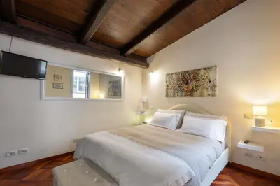 a bedroom with a large white bed and a window at Colosseum private terrace in Rome