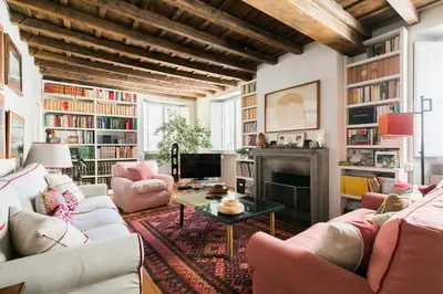 a living room with couches and a fireplace at Farnese Charming Apartment in Rome