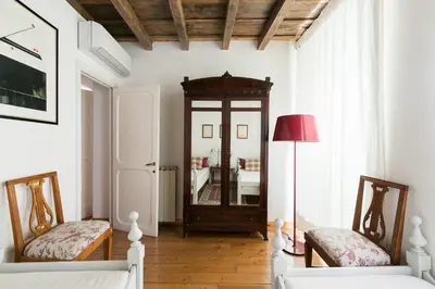 a living room with two chairs and a mirror at Farnese Charming Apartment in Rome
