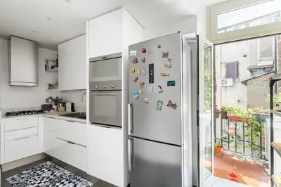 a kitchen with a stainless steel refrigerator with magnets at Farnese Charming Apartment in Rome