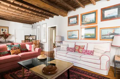 a living room with two couches and a table at Farnese Charming Apartment in Rome