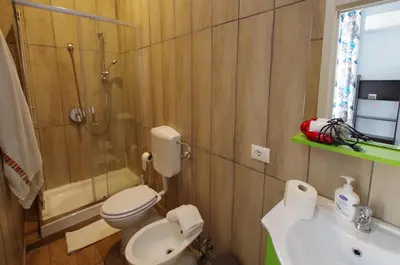 a bathroom with a toilet and a shower and a sink at Old Bakery Rome GuestHouse in Rome