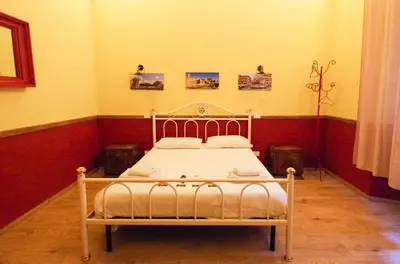 a bedroom with a white bed in a room at Old Bakery Rome GuestHouse in Rome