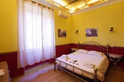 a bedroom with a bed and a window at Old Bakery Rome GuestHouse in Rome