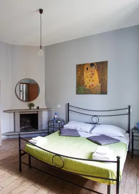 a bedroom with a bed and a painting on the wall at Old Bakery Rome GuestHouse in Rome
