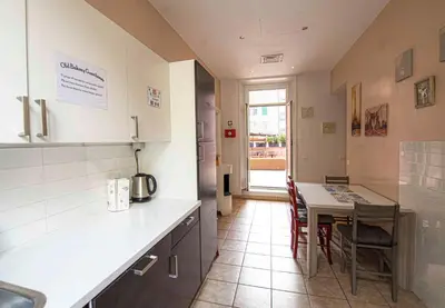 a kitchen with a counter and a table with chairs at Old Bakery Rome GuestHouse in Rome