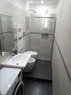 a bathroom with a toilet and a sink and a shower at Dino Apartment in Rome