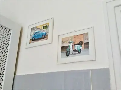 two framed pictures of a scooter on a wall at My Enchanting Roman Holiday in Rome