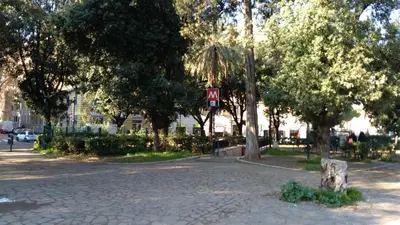 a park with trees and a cobblestone street at My Enchanting Roman Holiday in Rome