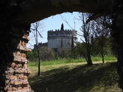 a castle is seen through a stone wall at My Enchanting Roman Holiday in Rome