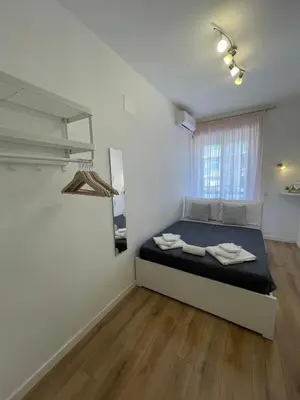 a white room with a bed and a mirror at Trastevere Sweet Rest in Rome