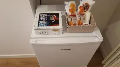 a white refrigerator with a basket on top of it at Trastevere Sweet Rest in Rome
