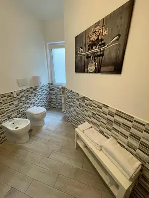 a bathroom with a toilet and a bidet and a sink at Trastevere Sweet Rest in Rome