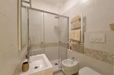 a bathroom with a sink and a toilet and a shower at San Pietro Moonlight Luxury Apartment in Rome