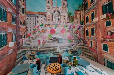 a table with a painting on the wall at San Pietro Moonlight Luxury Apartment in Rome