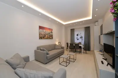 a living room with a couch and a table at San Pietro Moonlight Luxury Apartment in Rome