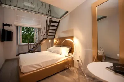 a bedroom with a bed and a staircase and a sink at Luxury on the River in Rome