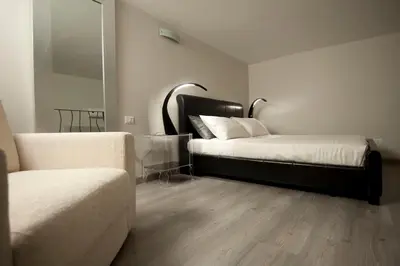 a bedroom with two beds and a mirror at Luxury on the River in Rome