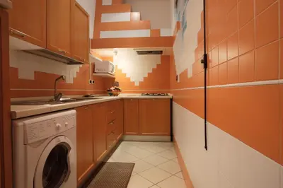 a small kitchen with a washing machine in it at Borgo Pio 91 in Rome