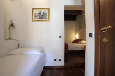 a room with a bedroom with a bed and a bed sqor at Borgo Pio 91 in Rome